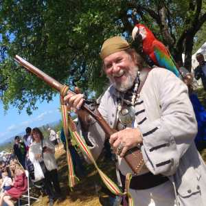 David Baker brandishes a riffle and the glee of impending violence.