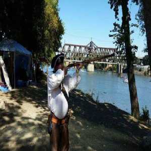 guy with riffle over river