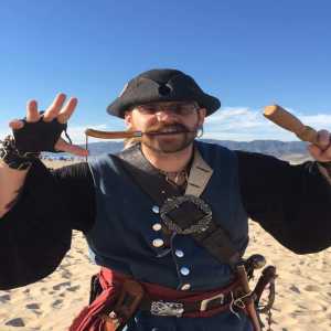 guy with knife in mouth on the beach