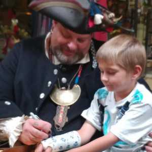 The Captain signs a child's cast.
