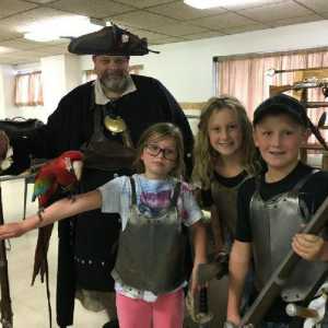 The Captain, Tova, and some children.